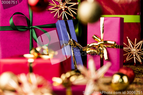 Image of Christmas Presents amidst Baubles and Stars