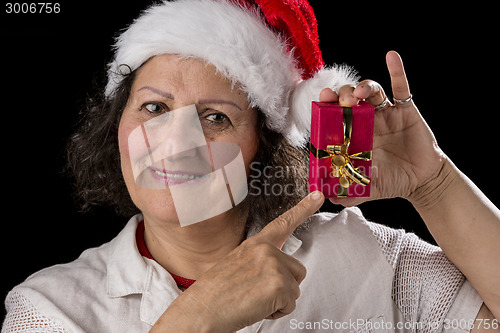 Image of Smiling Aged Woman Holding and Pointing at Red Gift