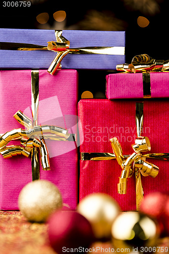 Image of Four Solid Gift Boxes and Festive Spheres