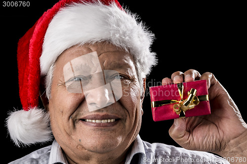 Image of Aged Gentleman with Red Cap Holding Small Gift