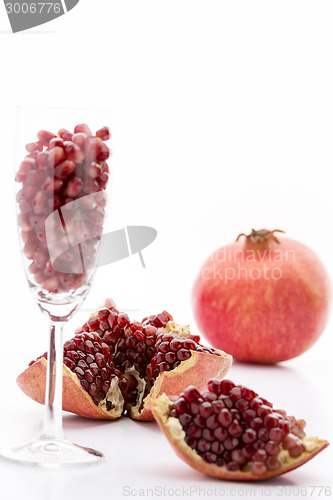 Image of Pomegranate seeds and a whole Punica granatum