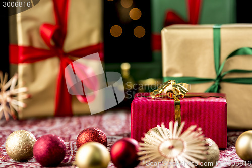 Image of Red Christmas Gift Amidst Baubles and Stars