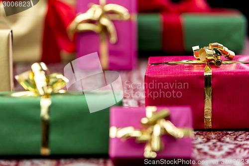 Image of Wrapped Presents with Bows in Gold and Red