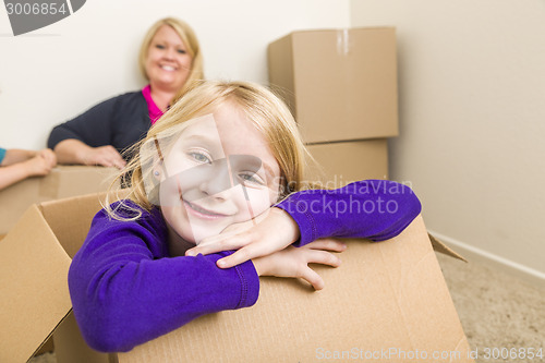 Image of Young Mother and Daughter Having Fun With Moving Boxes