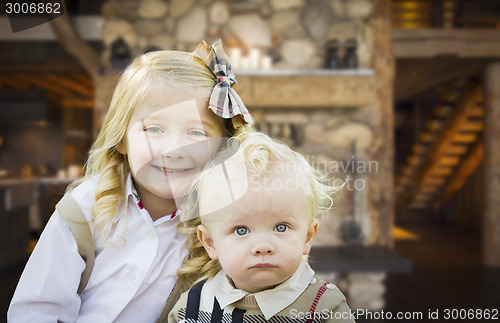 Image of Cute Brother and Sister Pose In Rustic Cabin