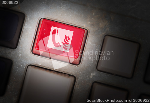 Image of Red button on a dirty old panel