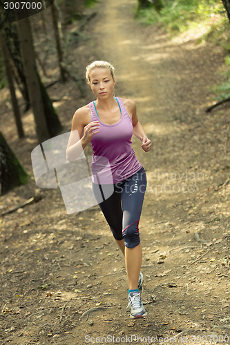 Image of Pretty young girl runner in the forest. 