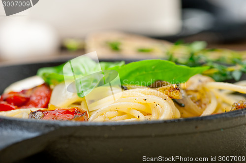 Image of spaghetti pasta with baked cherry tomatoes and basil 