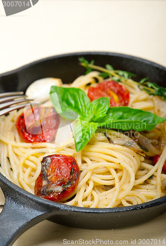 Image of spaghetti pasta with baked cherry tomatoes and basil 