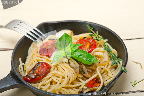 Image of spaghetti pasta with baked cherry tomatoes and basil 