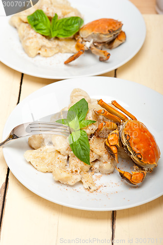 Image of Italian gnocchi with seafood sauce with crab and basil