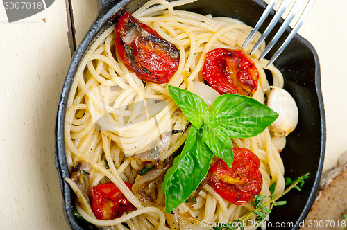 Image of spaghetti pasta with baked cherry tomatoes and basil 