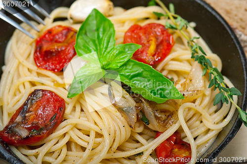 Image of spaghetti pasta with baked cherry tomatoes and basil 