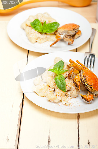 Image of Italian gnocchi with seafood sauce with crab and basil