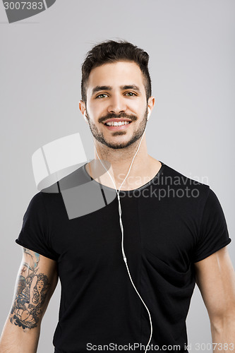 Image of Man smiling and listen music