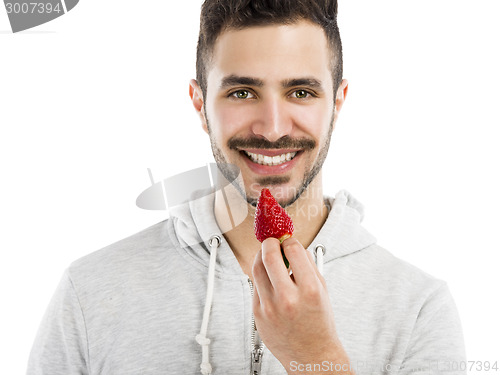 Image of Happy young eating a strawberry