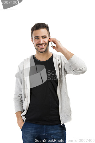 Image of Young man talking on cell phone