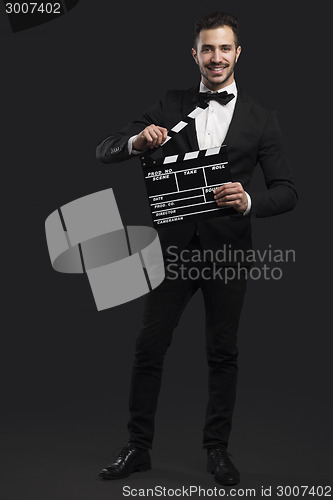Image of Business man holding a clapboard