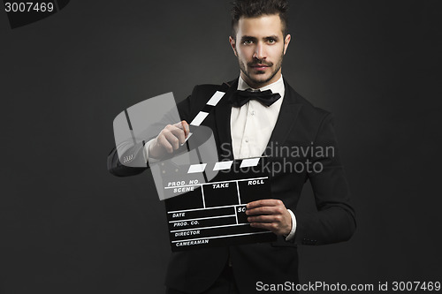 Image of Man holding a clapboard