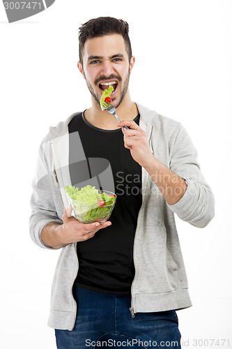 Image of Young man eating a salad