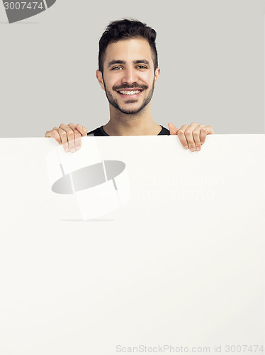 Image of Latin man holding a blank billboard