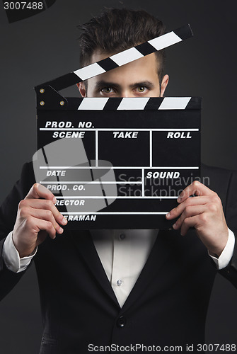 Image of Business man holding a clapboard