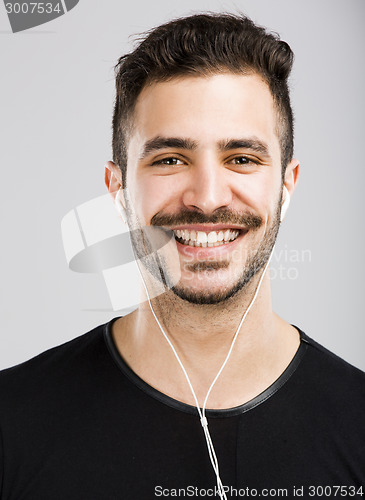 Image of Man smiling and listen music