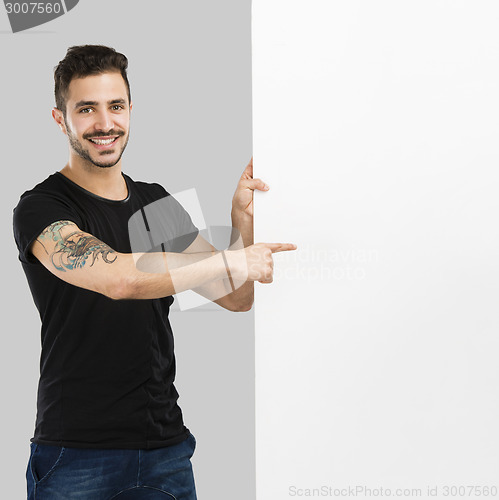 Image of Latin man holding a blank billboard
