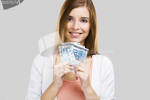 Image of Beautiful woman holding money