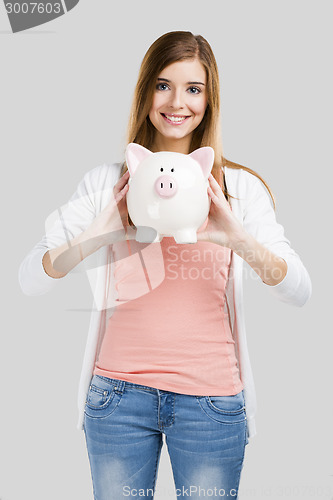 Image of Blonde woman with a piggy bank