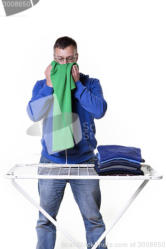 Image of man smells laundry