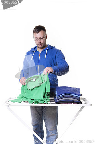Image of man putting laundry
