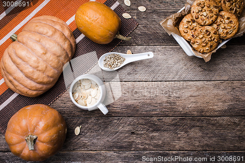 Image of Pumpkins, seeds and  cookies with nuts  on wood in Rustic style