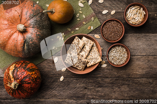 Image of Pumpkins with cookies and seeds on wood in Rustic style. 