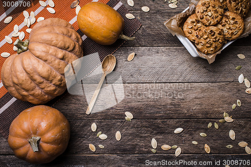 Image of Pumpkins and cookies on wood in Rustic style 
