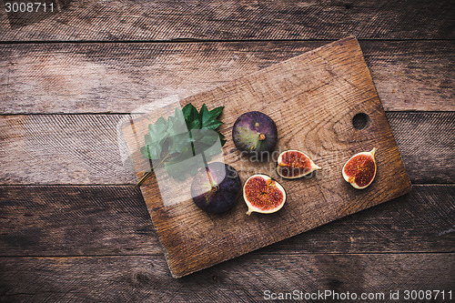 Image of Tasty Figs on chopping board and wooden table