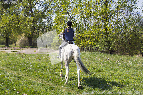 Image of Young woman riding