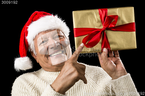 Image of Avid Aged Man Pointing At Golden Wrapped Present