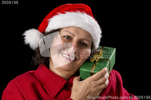 Image of Senior Lady with Santa Claus Hat and Wrapped Gift
