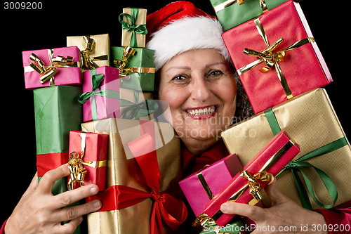 Image of Delighted Aged Woman Embosoming Wrapped Presents
