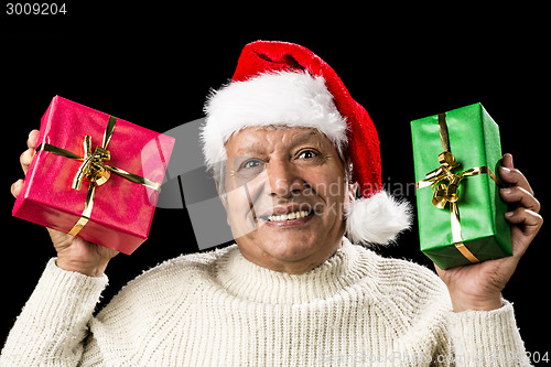 Image of Poignant Aged Man Showing Red And Green Xmas Gifts