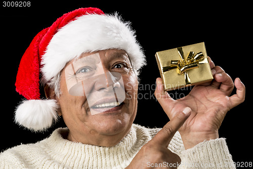 Image of Aged Man With Emphatic Look And Golden Gift
