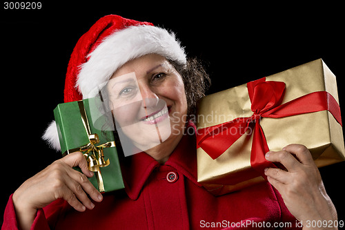 Image of Smiling Lady with Golden and Green Christmas Gifts

