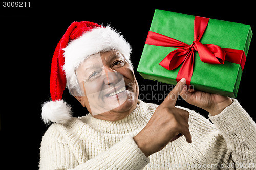 Image of Old Man With Gentle Smile Pointing At Green Gift
