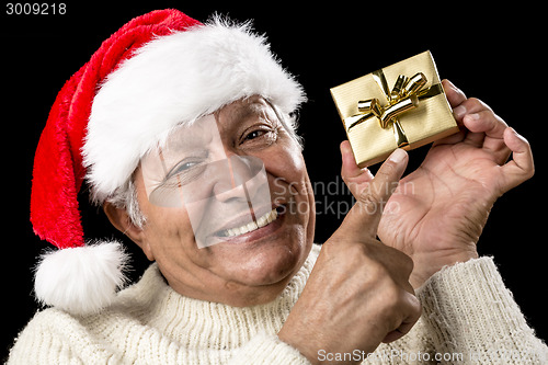 Image of Playful Male Pensioner Pointing At Golden Gift
