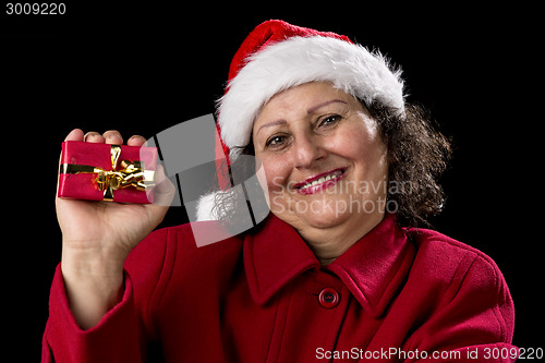 Image of Happy Aged Woman Presenting Red Wrapped Xmas Gift
