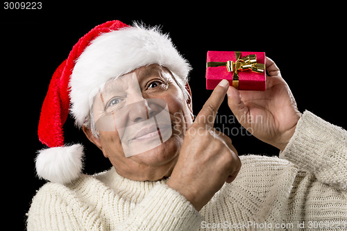 Image of Male Senior With Red Pompom Hat And Christmas Gift