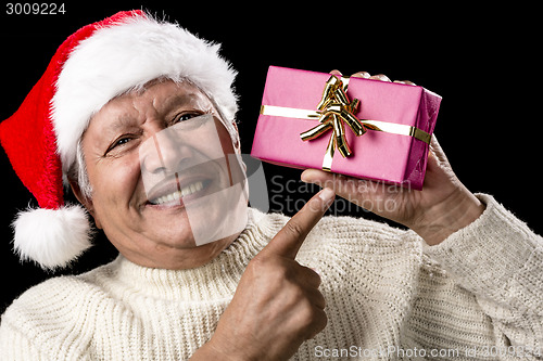 Image of Aged, But Vivid Gentleman Pointing At Wrapped Gift