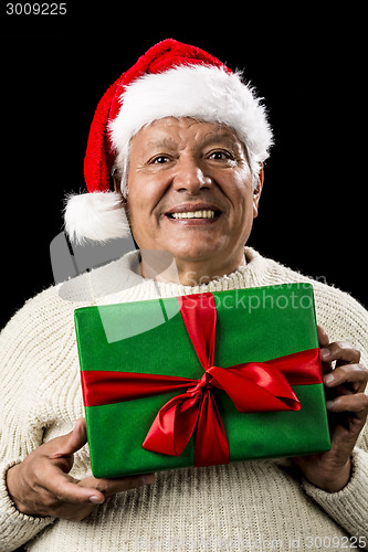 Image of Male Senior With Santa Claus Cap and Green Gift