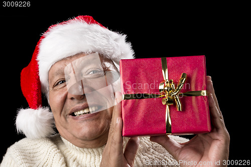 Image of Smiling Old Man With Red Wrapped Christmas Gift